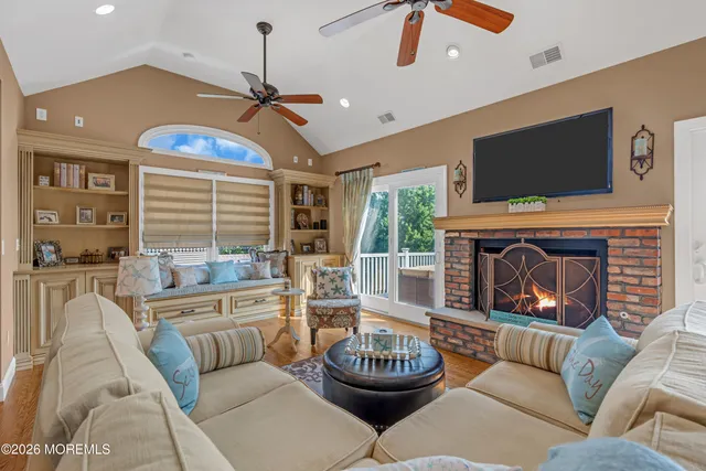 a living room with furniture a fireplace and a flat screen tv