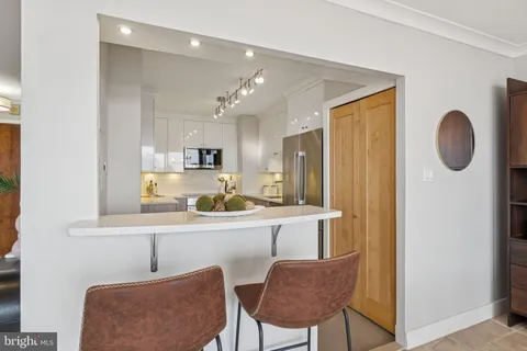 a kitchen with stainless steel appliances granite countertop a sink and a refrigerator