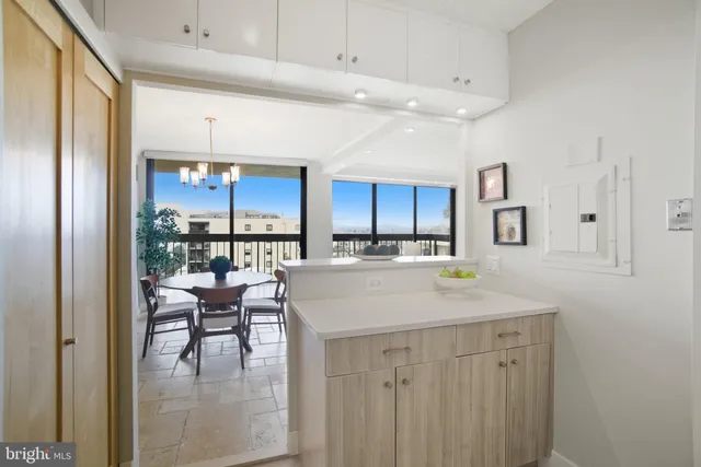 a view of kitchen with kitchen island dining table and chairs