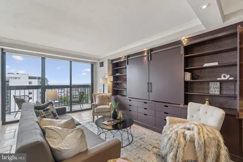 a living room with furniture and a floor to ceiling window