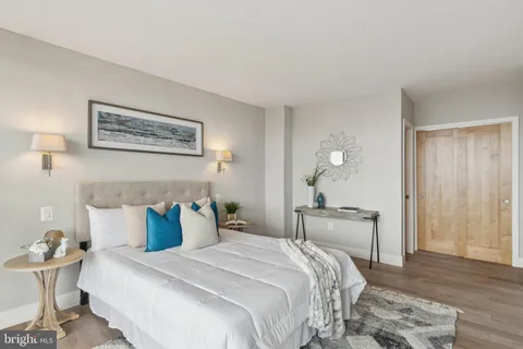 a bedroom with bed and wooden floor