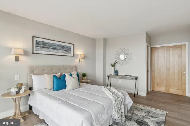 a bedroom with bed and wooden floor