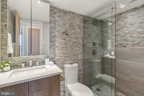 a bathroom with a sink toilet and shower