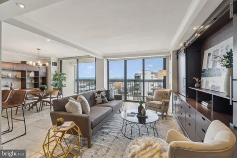 a living room with furniture fireplace and a large window
