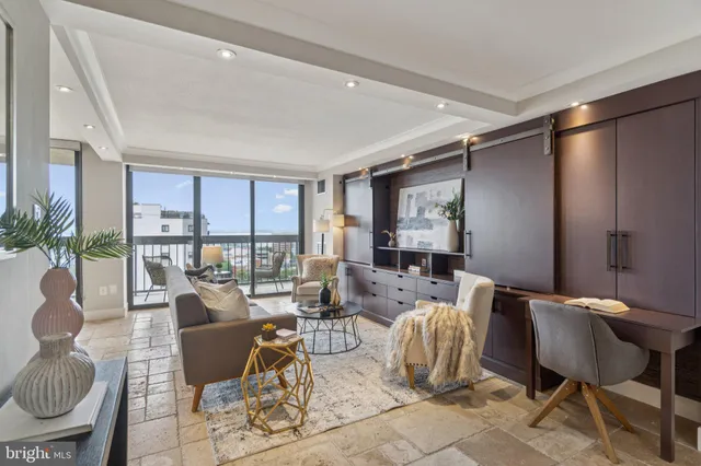 a living room with furniture a lamp and large window