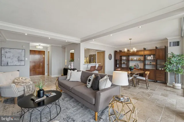 a living room with furniture and view of kitchen