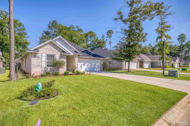 a front view of a house with a garden and yard