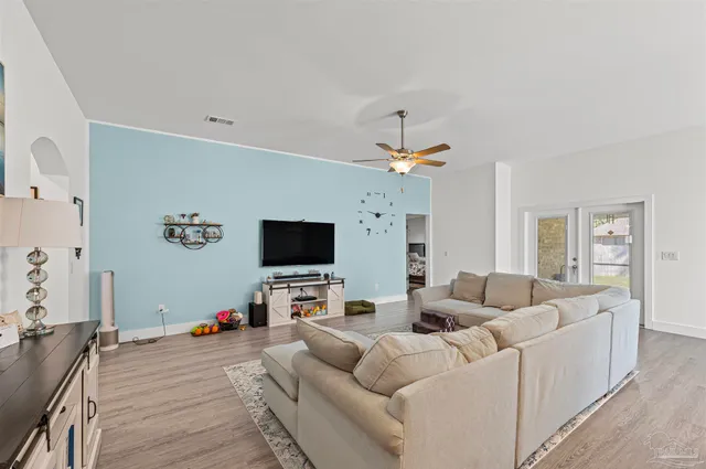 a living room with furniture and a flat screen tv