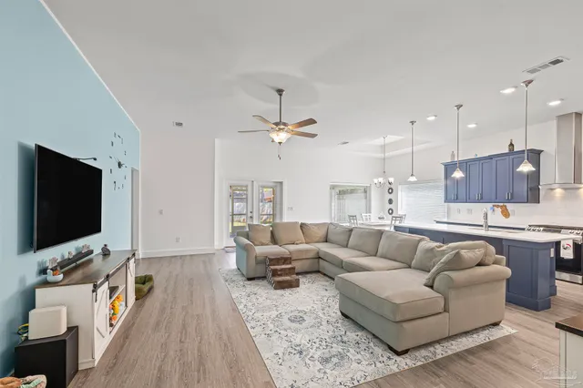 a kitchen with stainless steel appliances a stove a refrigerator and cabinets