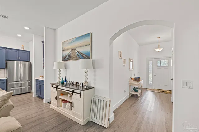 a living room with furniture and kitchen view