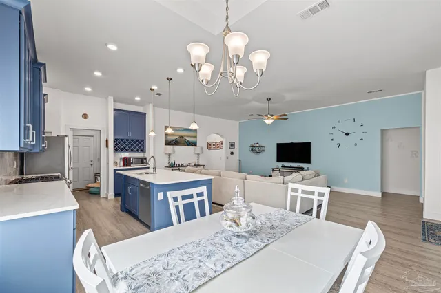a kitchen with a sink refrigerator and cabinets