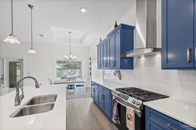 a kitchen with a sink appliances and cabinets