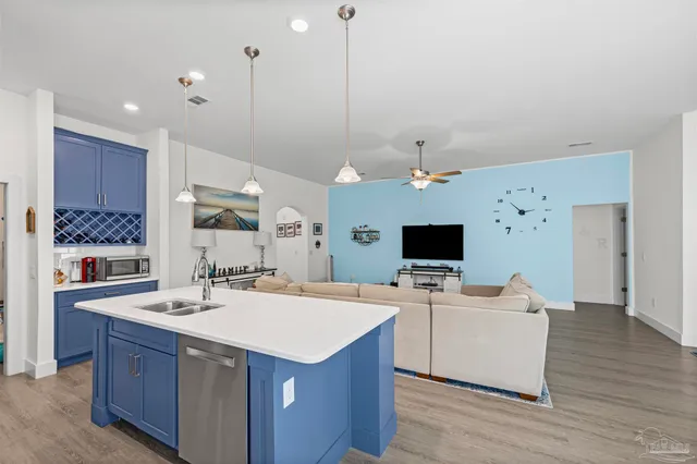 a kitchen with stainless steel appliances granite countertop a stove a refrigerator and a cabinets