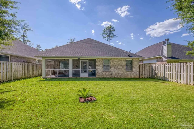 a utility room with fridge dryer and washer