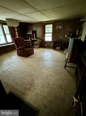 a living room with furniture gym equipment and a window