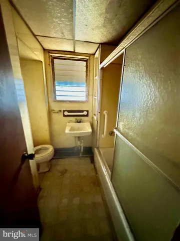 a bathroom with sink toilet and shower