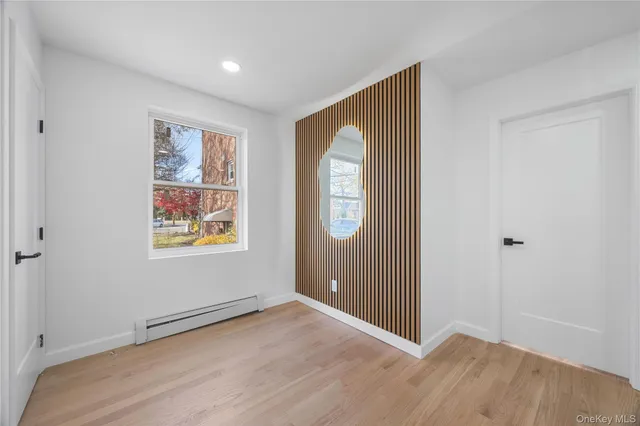 an entryway in front room with wooden floor