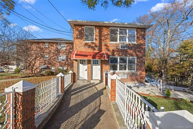a view of a yard with plants and a fountain