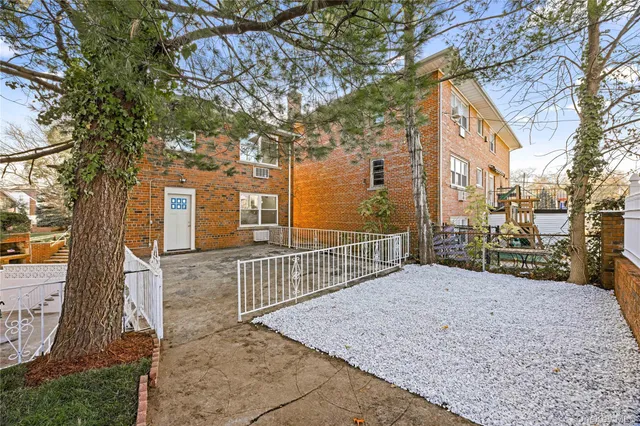 a view of a house with a wooden fence