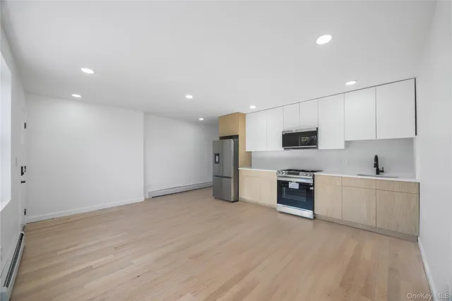a kitchen with wooden cabinets and stainless steel appliances