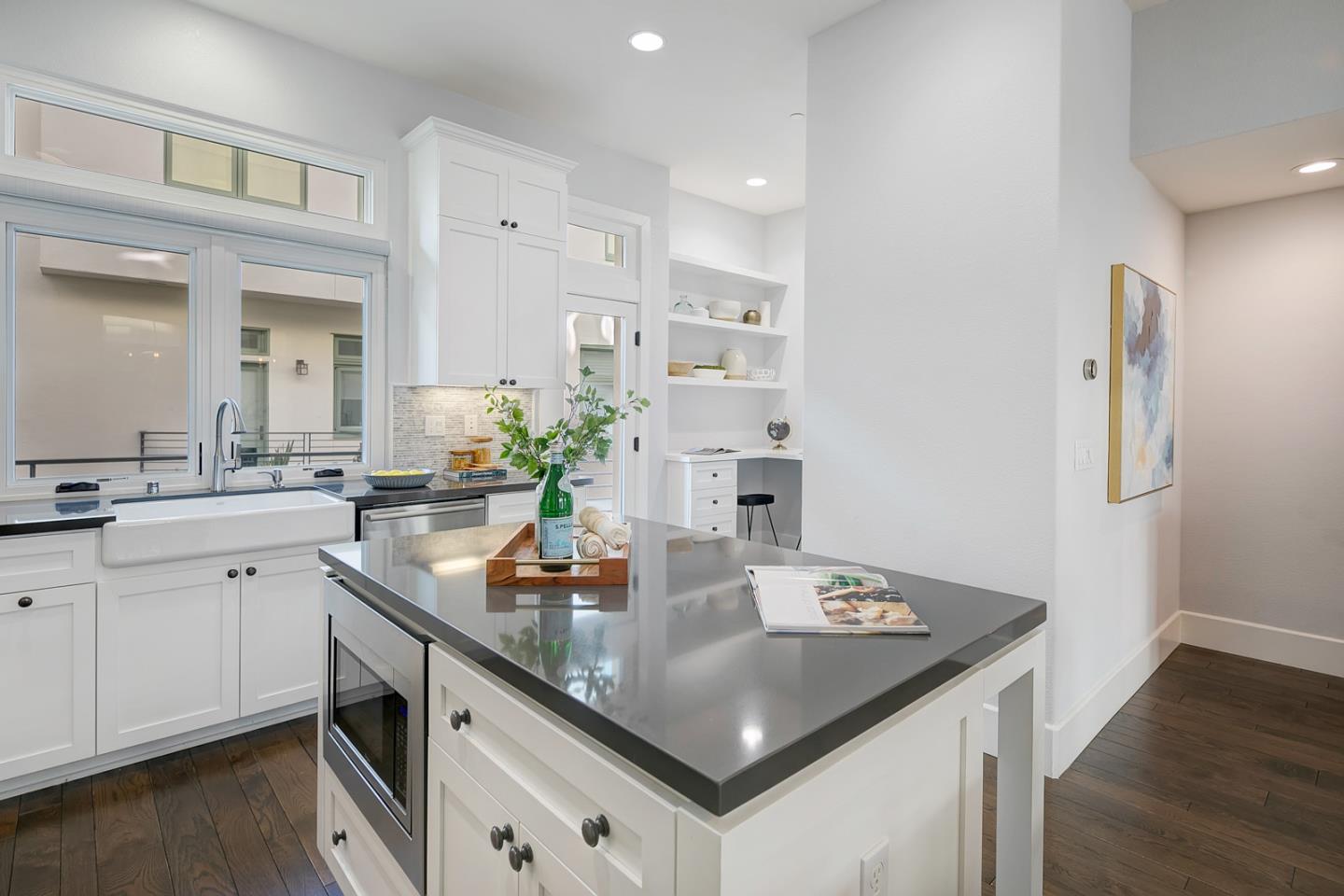 534 Fierro Loop Campbell, CA 95008 - Photo 19 of 55 a kitchen with white cabinets a sink dishwasher and a stove with wooden floor