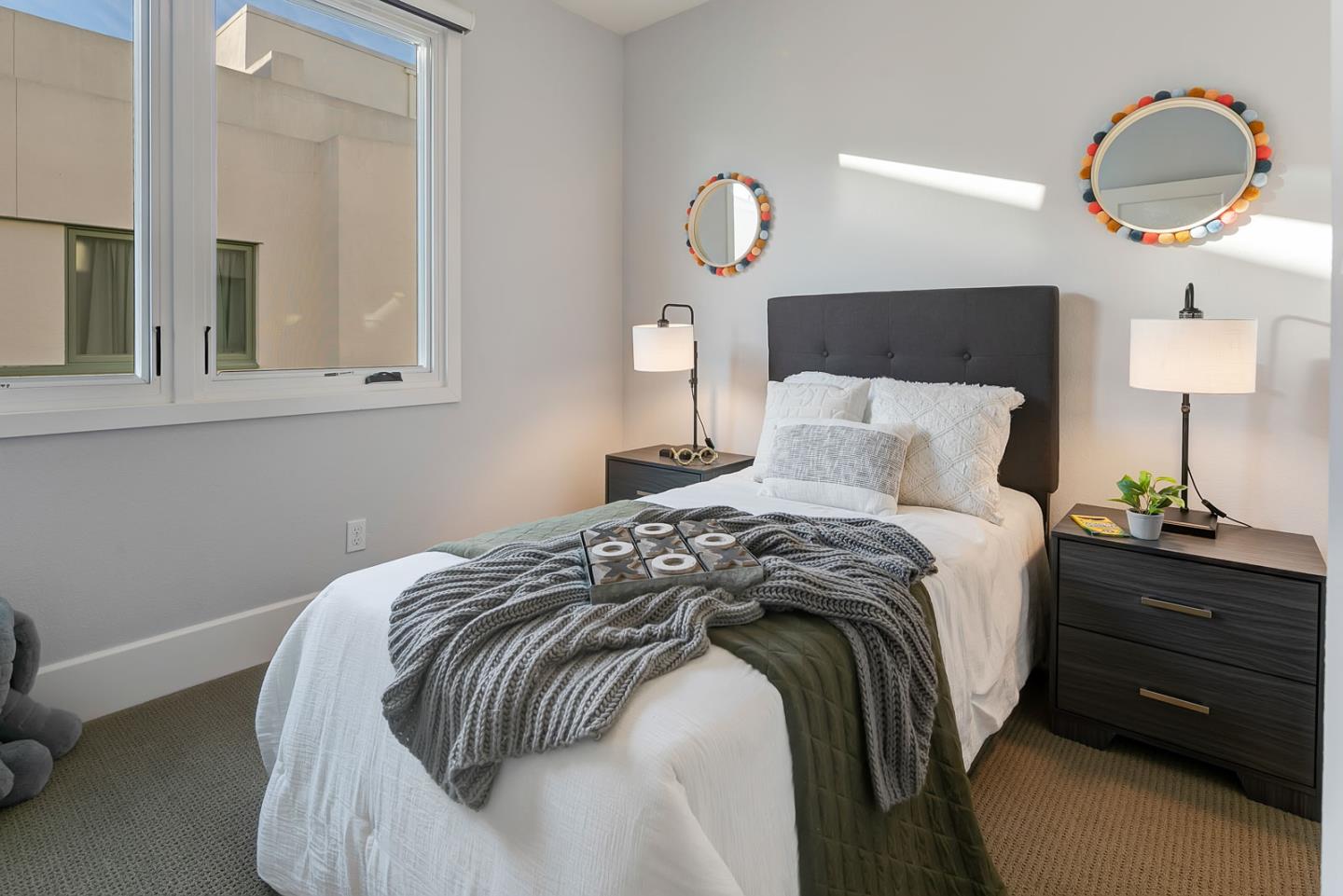 534 Fierro Loop Campbell, CA 95008 - Photo 37 of 55 a bedroom with a bed and a chandelier