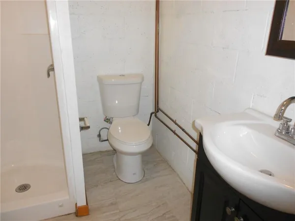 a white toilet sitting next to a bathroom sink