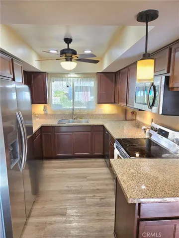 a bathroom with a shower sink vanity mirror and toilet