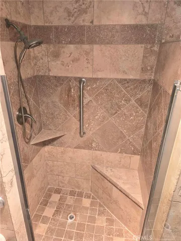 a view of living room with furniture and mirror