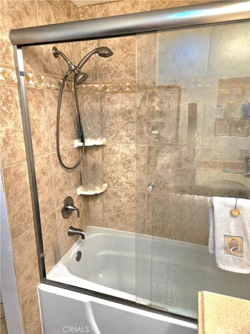 a bedroom with a large bed and a large window