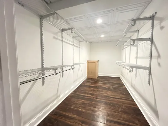 a view of a room with wooden floor