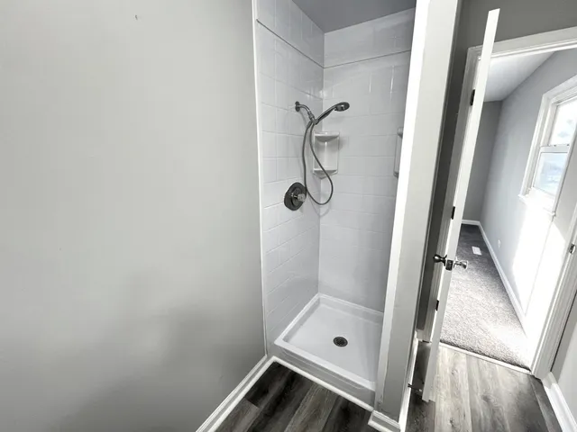 an empty room with closet and a ceiling fan