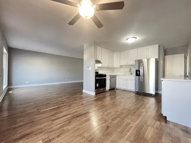 a view of a kitchen with a stove cabinets and wooden floor