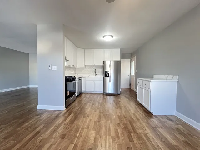 a kitchen with stainless steel appliances a refrigerator and a stove top oven