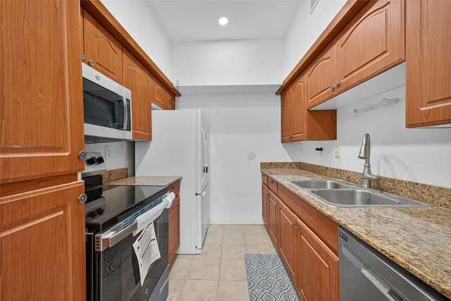 a kitchen that has a sink and a stove