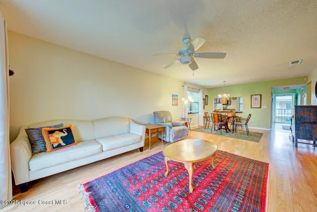 a living room with furniture a rug and a chandelier