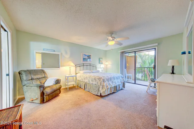 a spacious bedroom with a bed and a couch