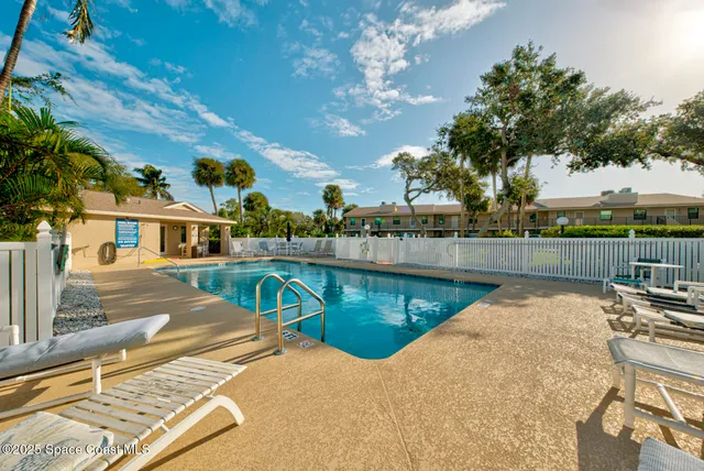 a view of swimming pool with outdoor seating and yard
