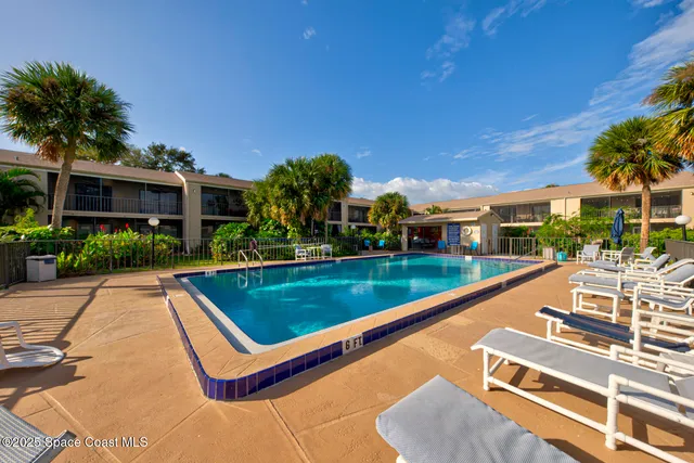 a view of a patio with couches table and chairs and potted plants