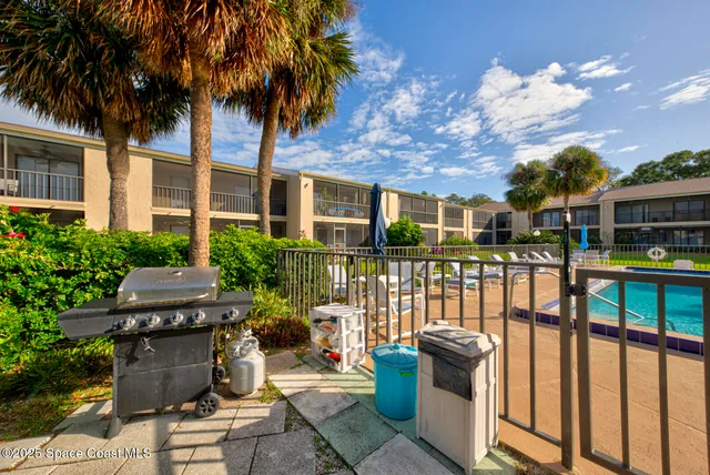 a view of a roof deck with table and chairs