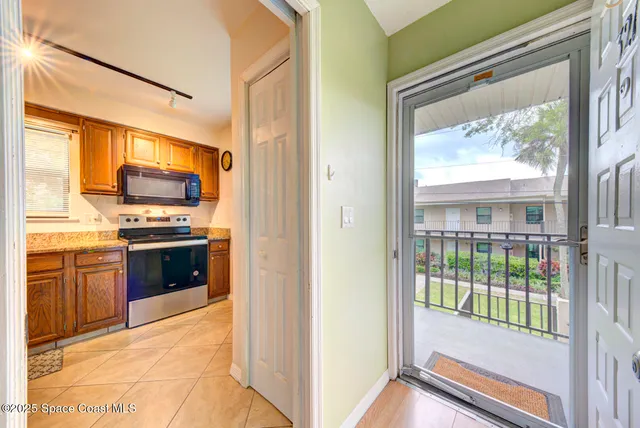 a view of kitchen with kitchen island wooden floor and electronic appliances