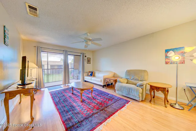 a living room with furniture rug and a flat screen tv