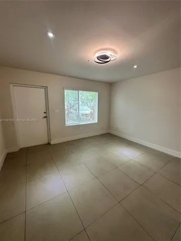 an empty room with a empty space and windows