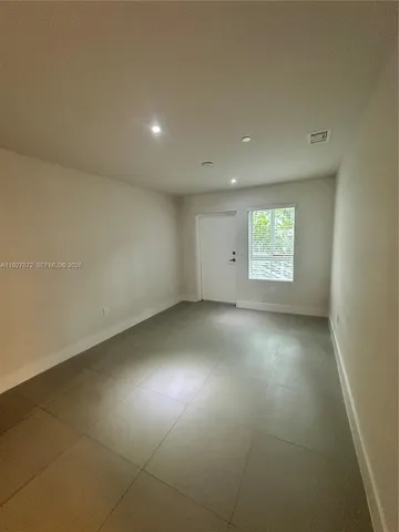 an empty room with a empty space and windows