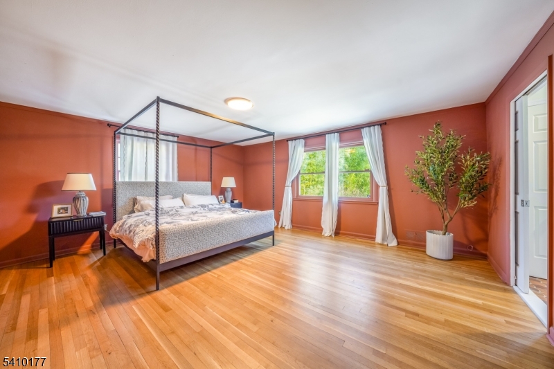 250 Old Short Hills Road Short Hills, NJ 07078 - Photo 15 of 38 a bedroom with a bed and wooden floor