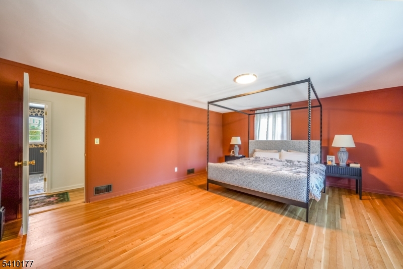 250 Old Short Hills Road Short Hills, NJ 07078 - Photo 16 of 38 a bedroom with a bed and wooden floor