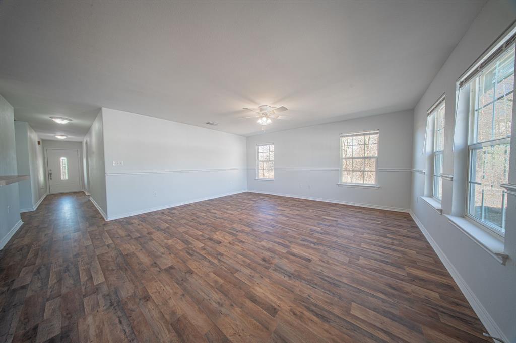 121 Washburn Road North Bells, TX 75414 - Photo 12 of 40 a view of empty room with wooden floor and fan