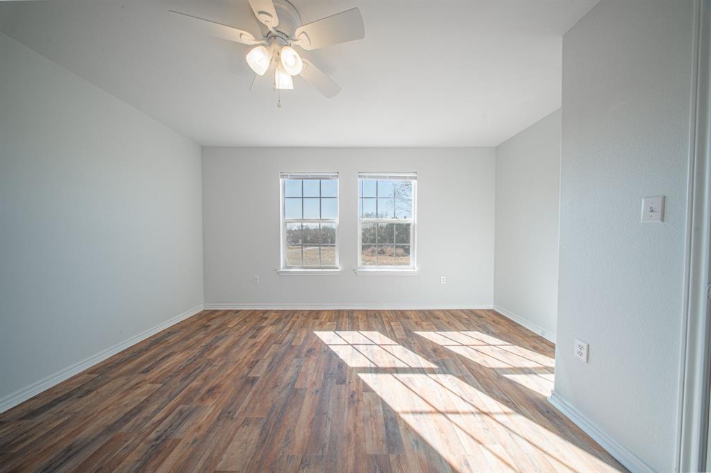 121 Washburn Road North Bells, TX 75414 - Photo 14 of 40 wooden floor in an empty room with a window