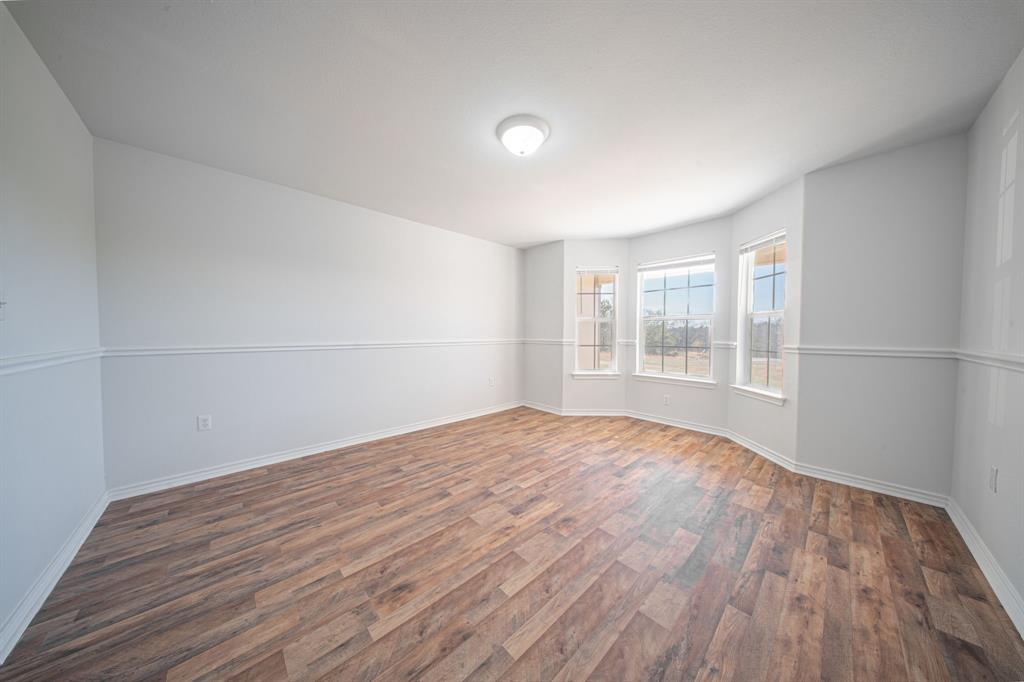 121 Washburn Road North Bells, TX 75414 - Photo 16 of 40 a view of empty room with wooden floor and fan
