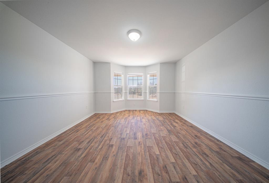 121 Washburn Road North Bells, TX 75414 - Photo 17 of 40 an empty room with wooden floor and windows